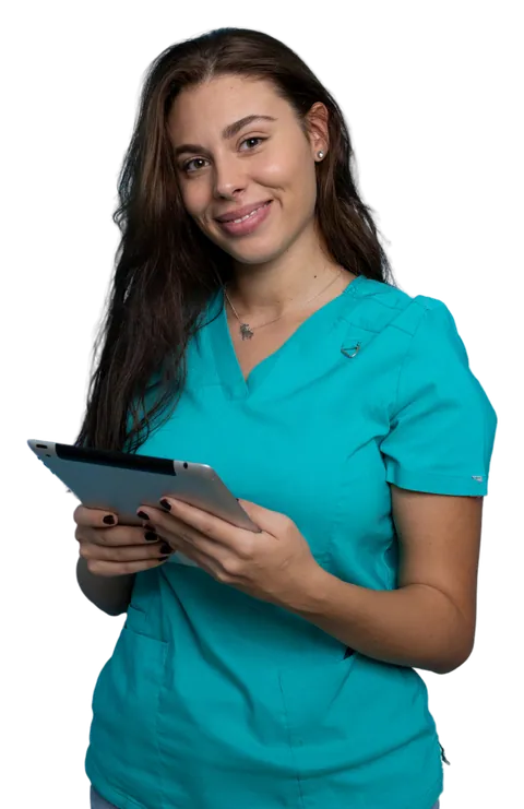 A care worker in teal scrubs holding a tablet