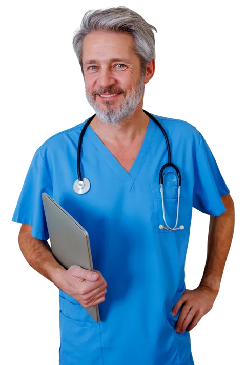 An experienced nurse with grey hair in blue scrubs, holding a tablet