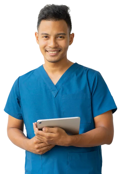 A young support worker in blue scrubs holding a tablet