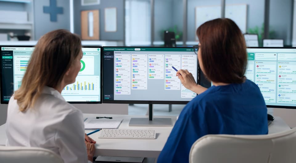 Two colleagues going over a schedule on their screens
