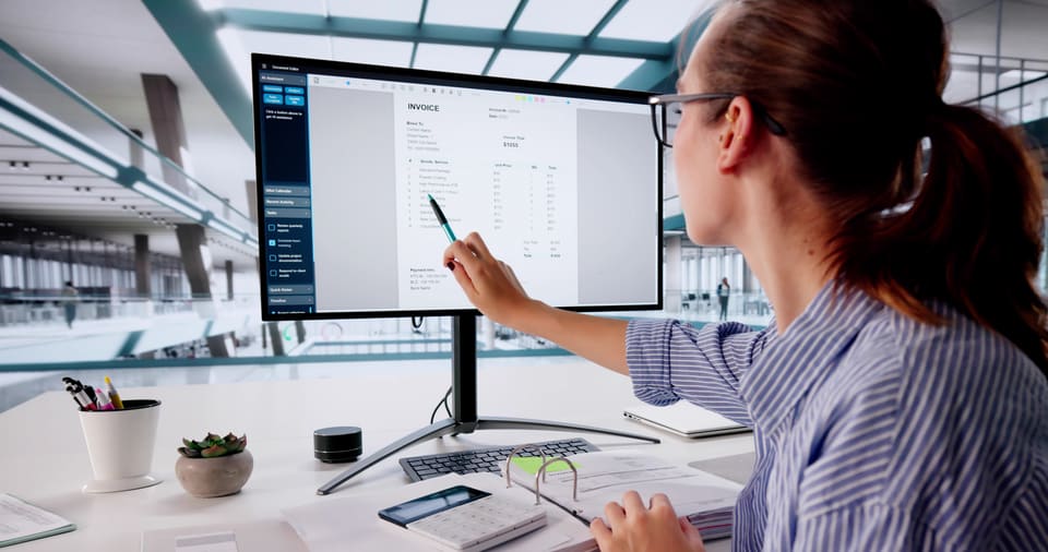A woman checking invoices on her computer screen