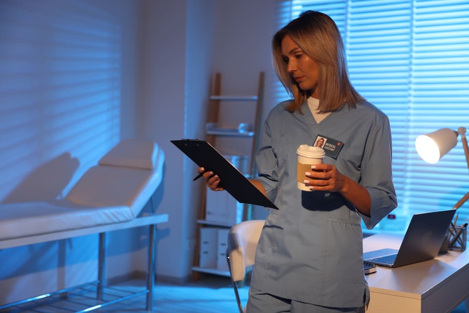 A carer checking a clipboard on an evening shift