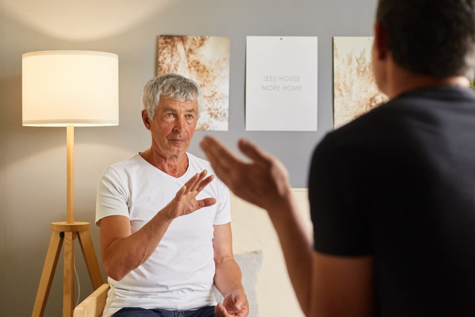 A counsellor listening to a man in a quiet room