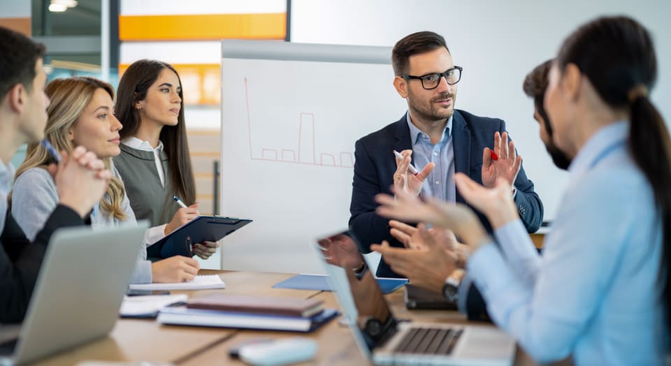 Colleagues talking through a plan at a table