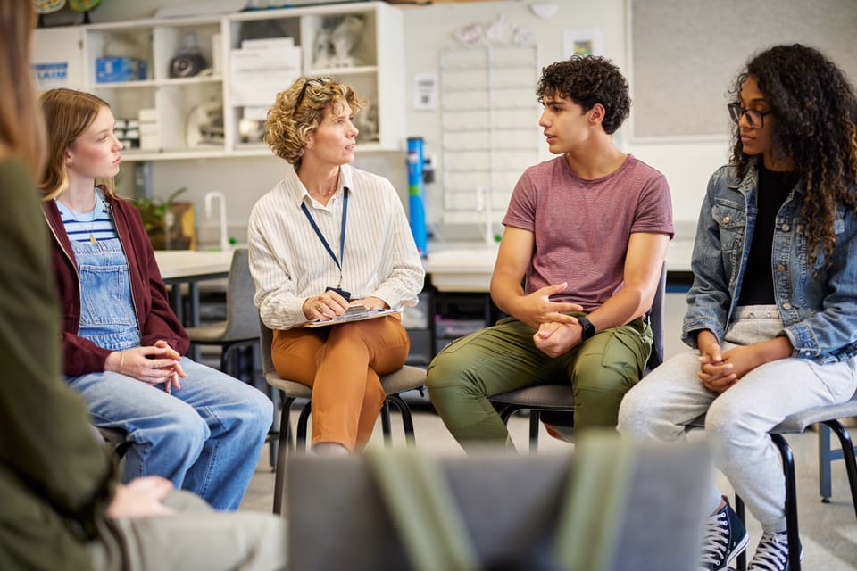 A peer support group talking in a circle