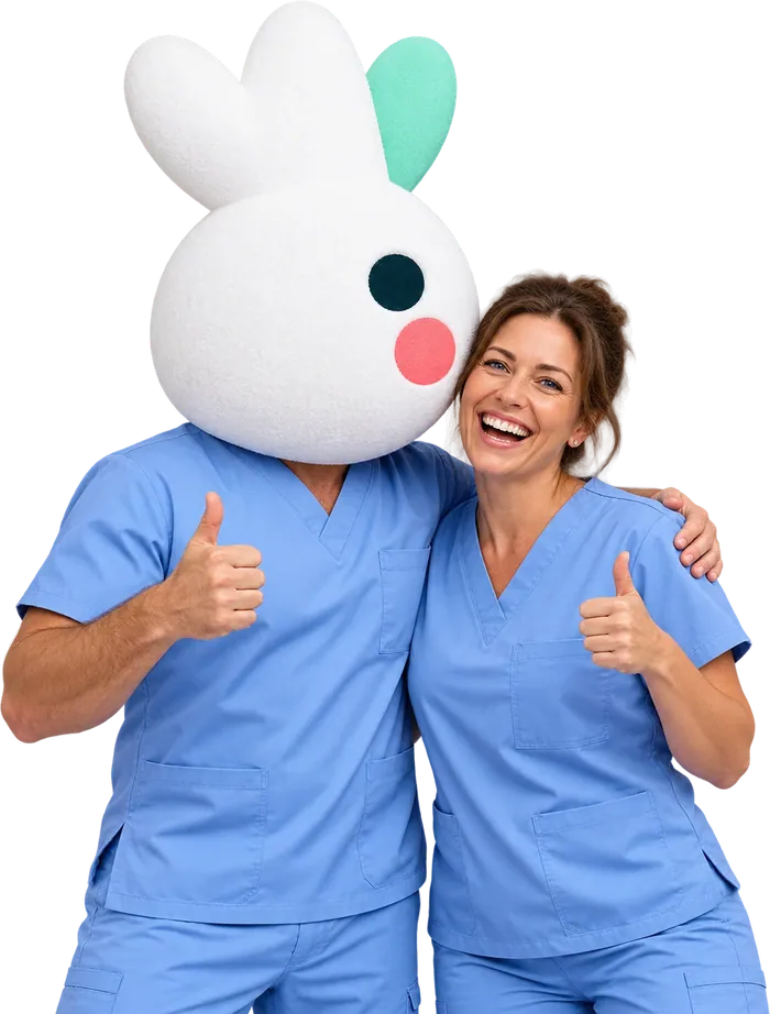 Two carers in blue scrubs giving a thumbs up, one of them wearing a giant Corella bird head